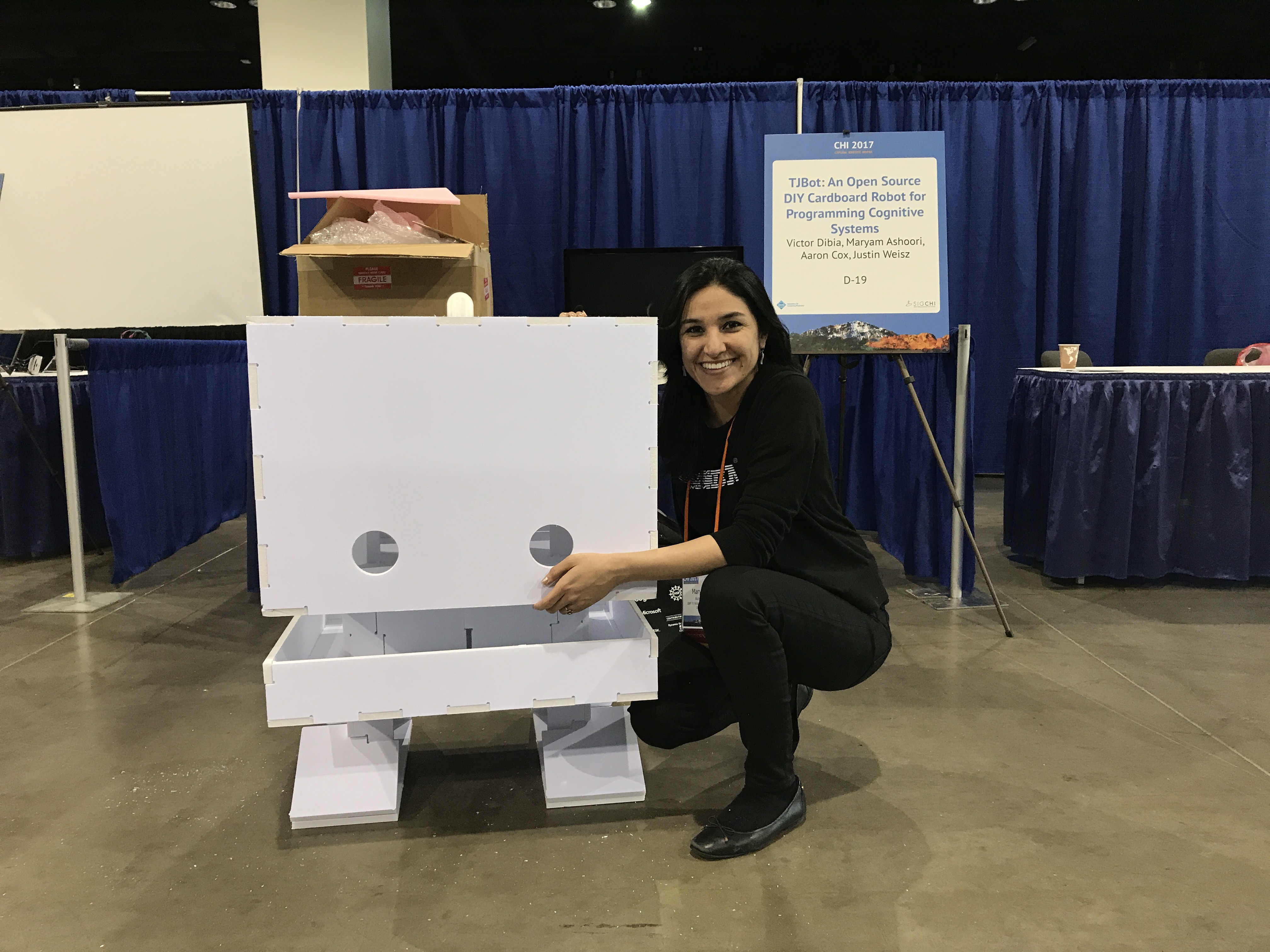 Giant TJBot posing with creator Maryam Ashoori at CHI 2017
